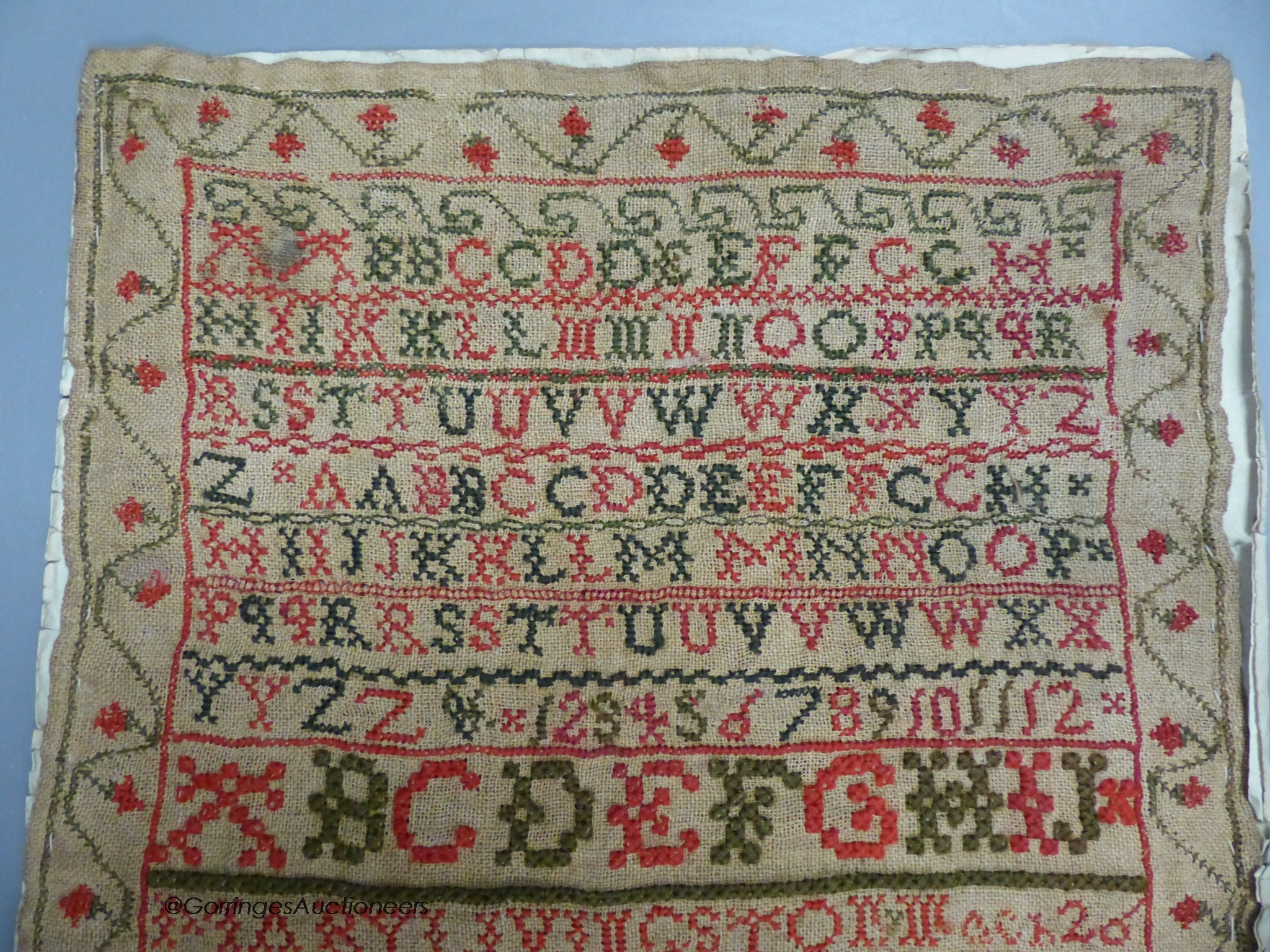 A cross stitch sampler, 41cm high, 29.5cm wide